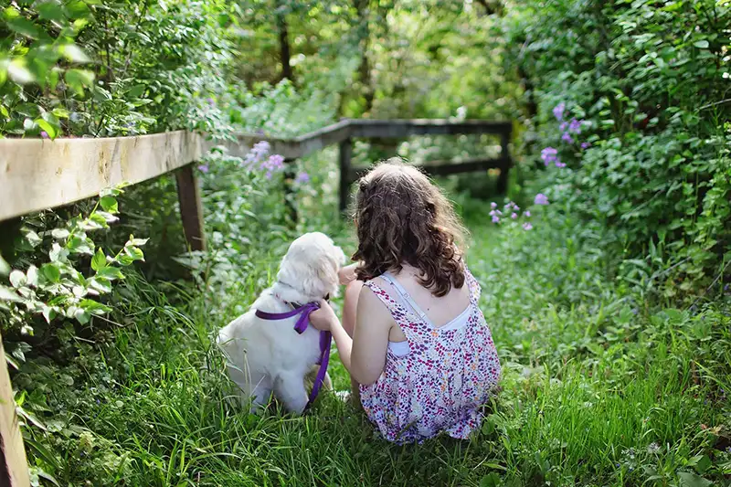 Girl and a puppy in a forest